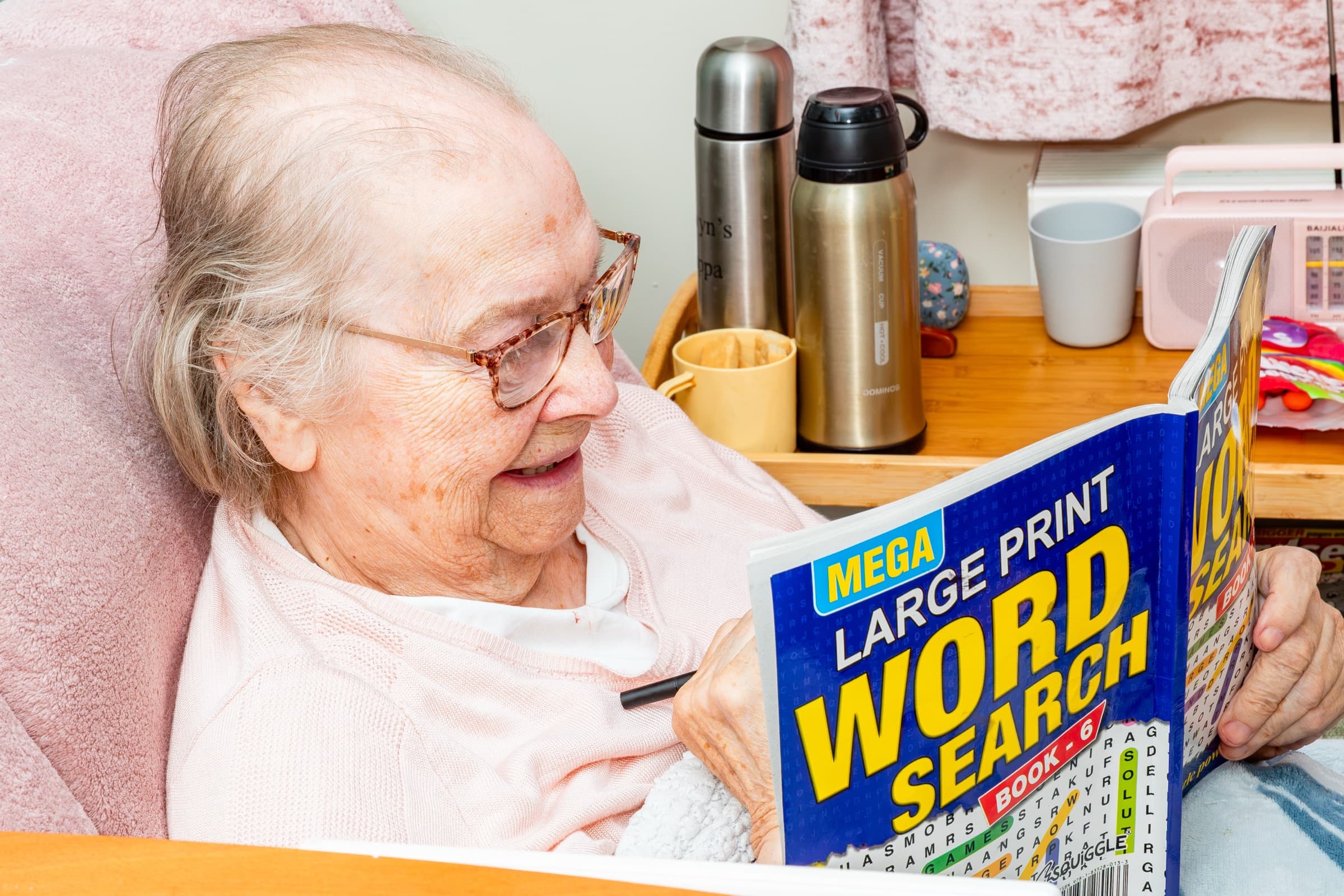 A resident enjoying a large-print word search