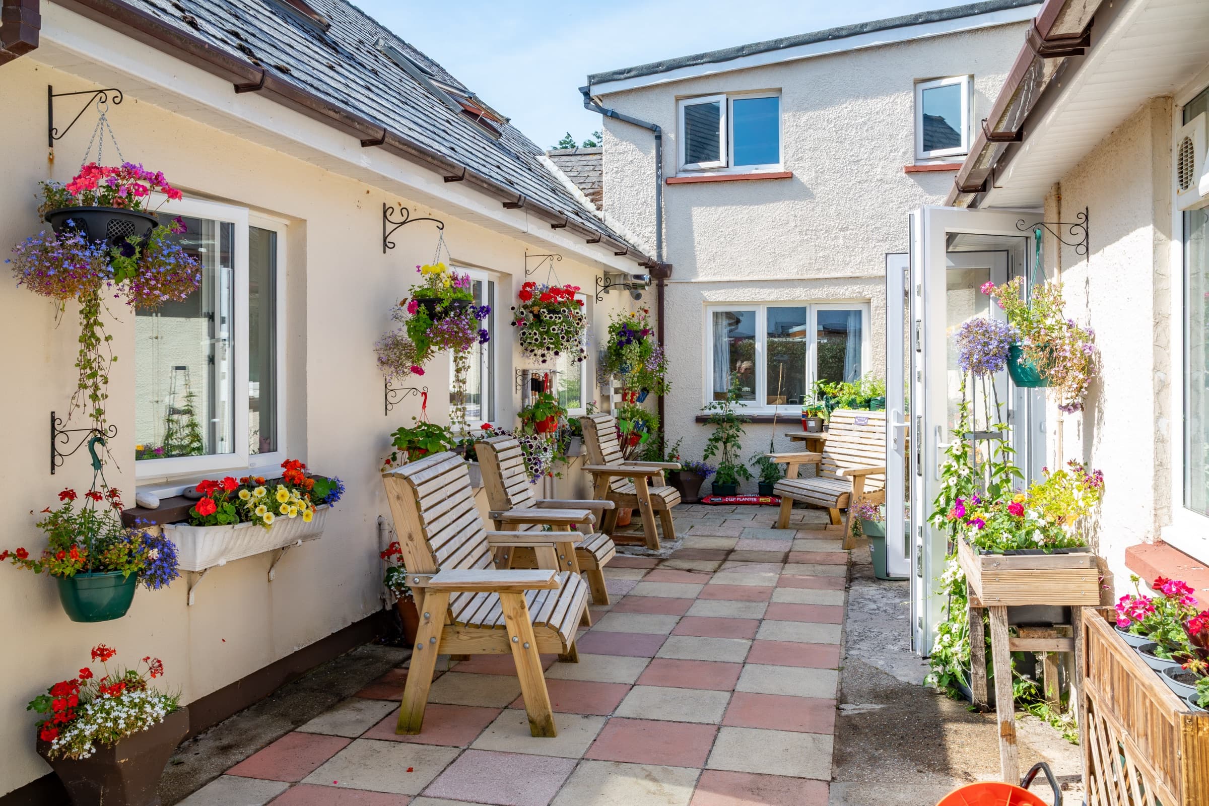 Sheltered courtyard with garden seating and flowers
